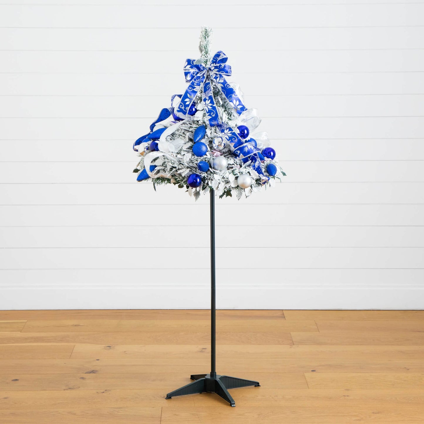 5' Pre-Lit Flocked Christmas Tree with blue ornaments and ribbons on a stand on Tampa Home & Garden Store