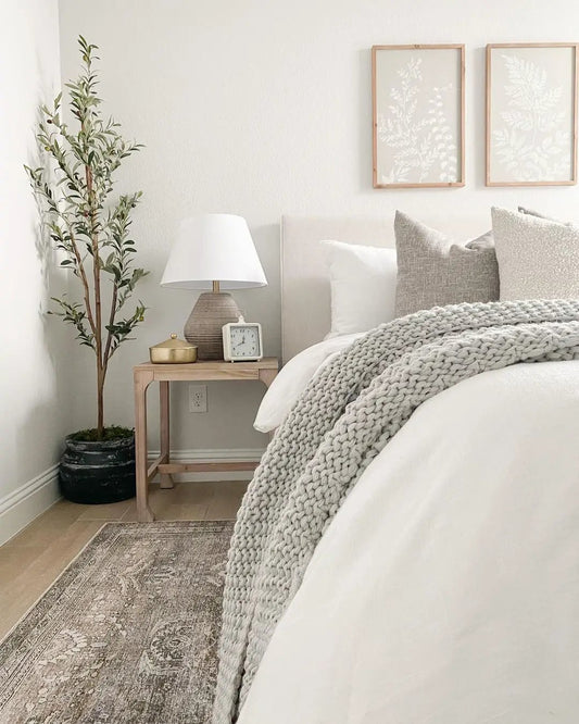 Slim Olive Artificial Tree 5.5 ft, slender olive leaves in a dark pot beside a neutral bedroom on Tampa Home & Garden Store