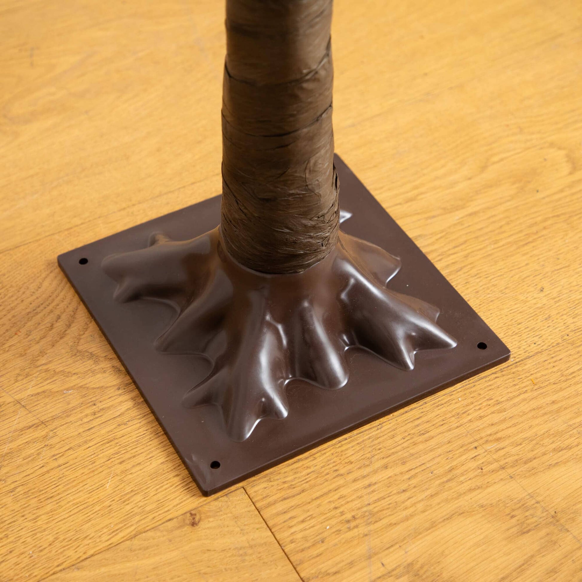 6' Pre-Lit Bright Autumn Eucalyptus Tree trunk close-up with brown wrap on dark base plate on Tampa Home & Garden Store