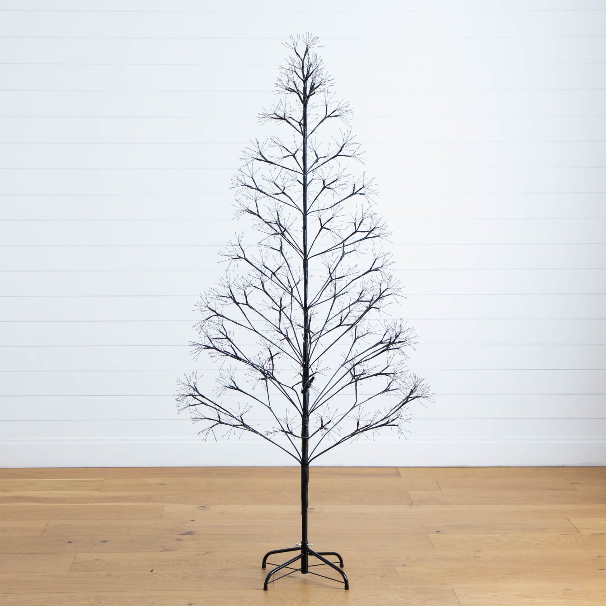 Halloween tree 6 ft black starburst with bare branches on metal stand on Tampa Home & Garden Store