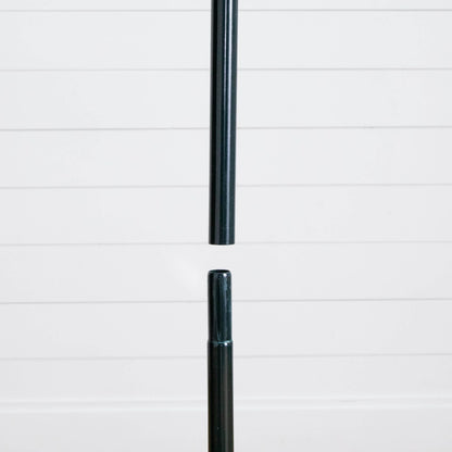 Christmas tree stand pole, black metal, shown against white shiplap backdrop on Tampa Home & Garden Store