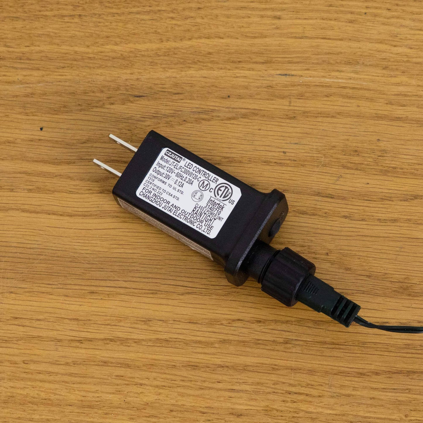 LED controller for Nearly Natural 6' pre-lit Christmas tree, black unit on wood floor on Tampa Home & Garden Store