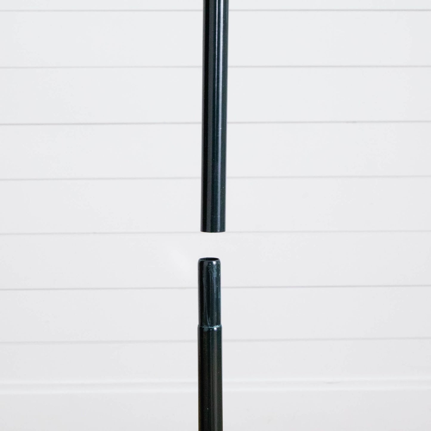 Black metal tree pole segment from Nearly Natural pop-up Christmas tree against white backdrop on Tampa Home & Garden Store