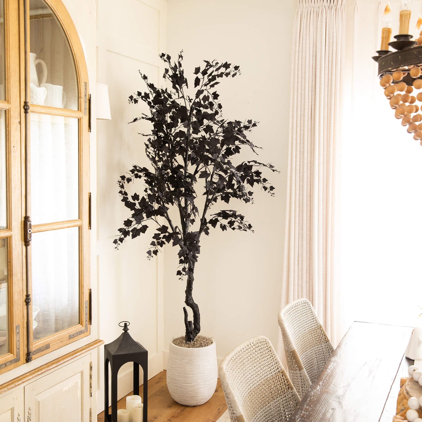 7' Nearly Natural Halloween Black Maple Tree in white planter with black leaves indoors on Tampa Home & Garden Store