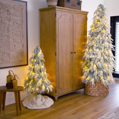 7' Flocked Down Swept artificial Christmas tree with 300 LED lights beside a wooden cabinet on Tampa Home & Garden Store