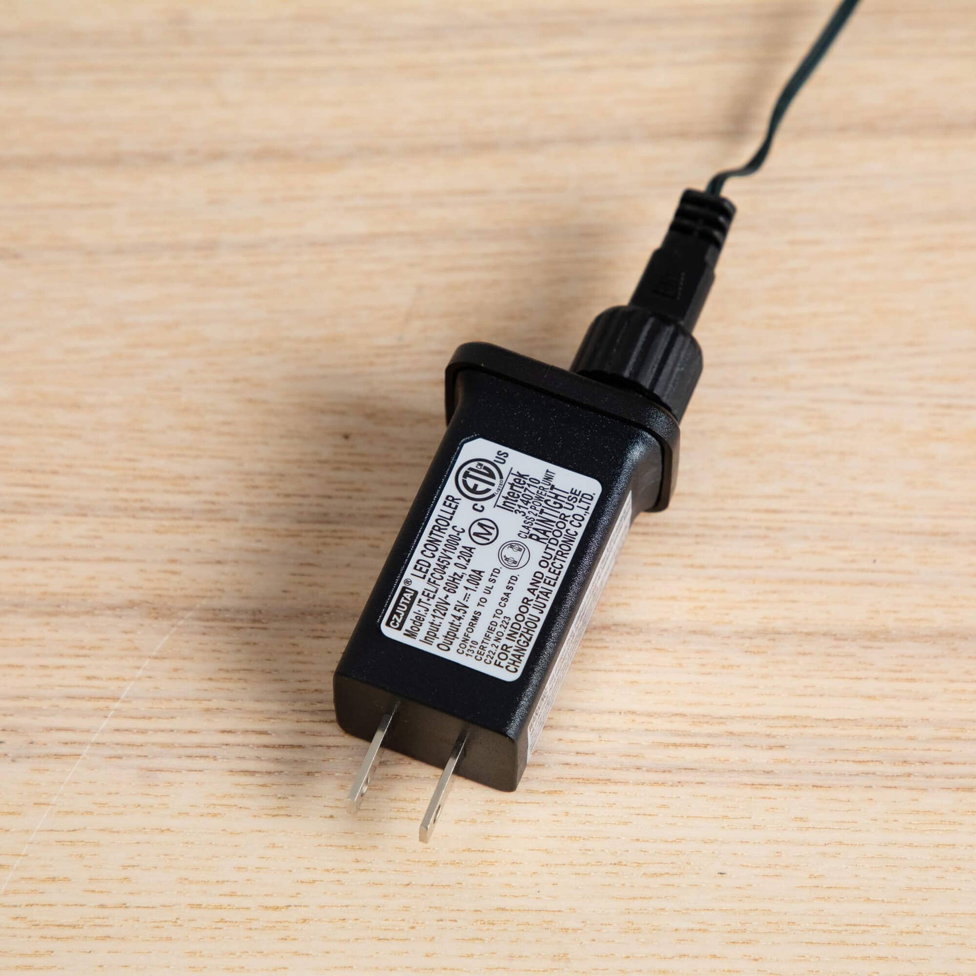 Black LED power adapter with cord and plug for a pre-lit tree lighting system on Tampa Home & Garden Store