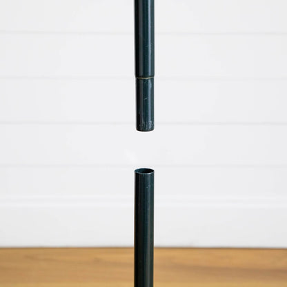 Dark green pole segments for Nearly Natural pop up tree against white wall on Tampa Home & Garden Store