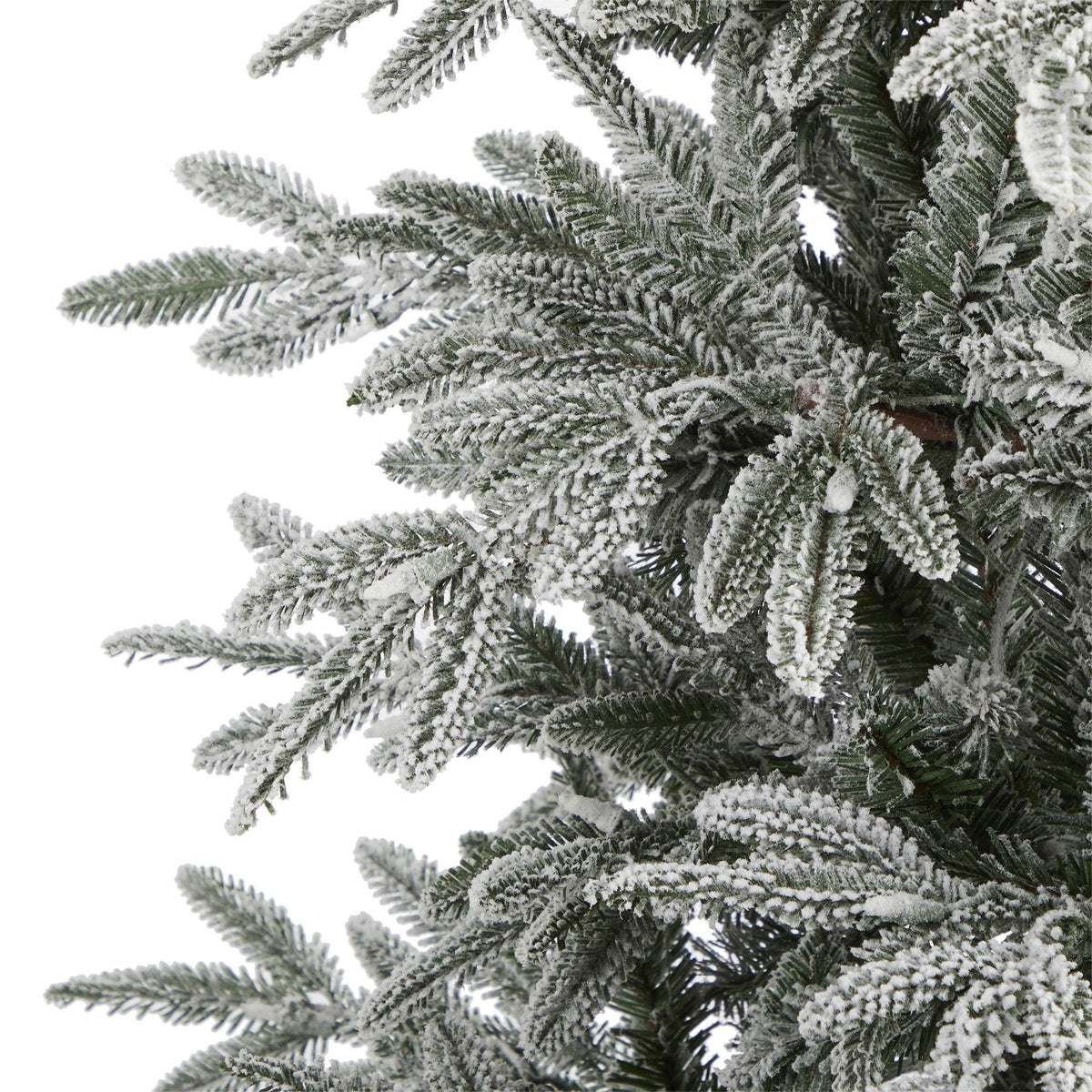 Flocked Manchester Spruce artificial Christmas tree branches with snow on green needles on Tampa Home & Garden Store