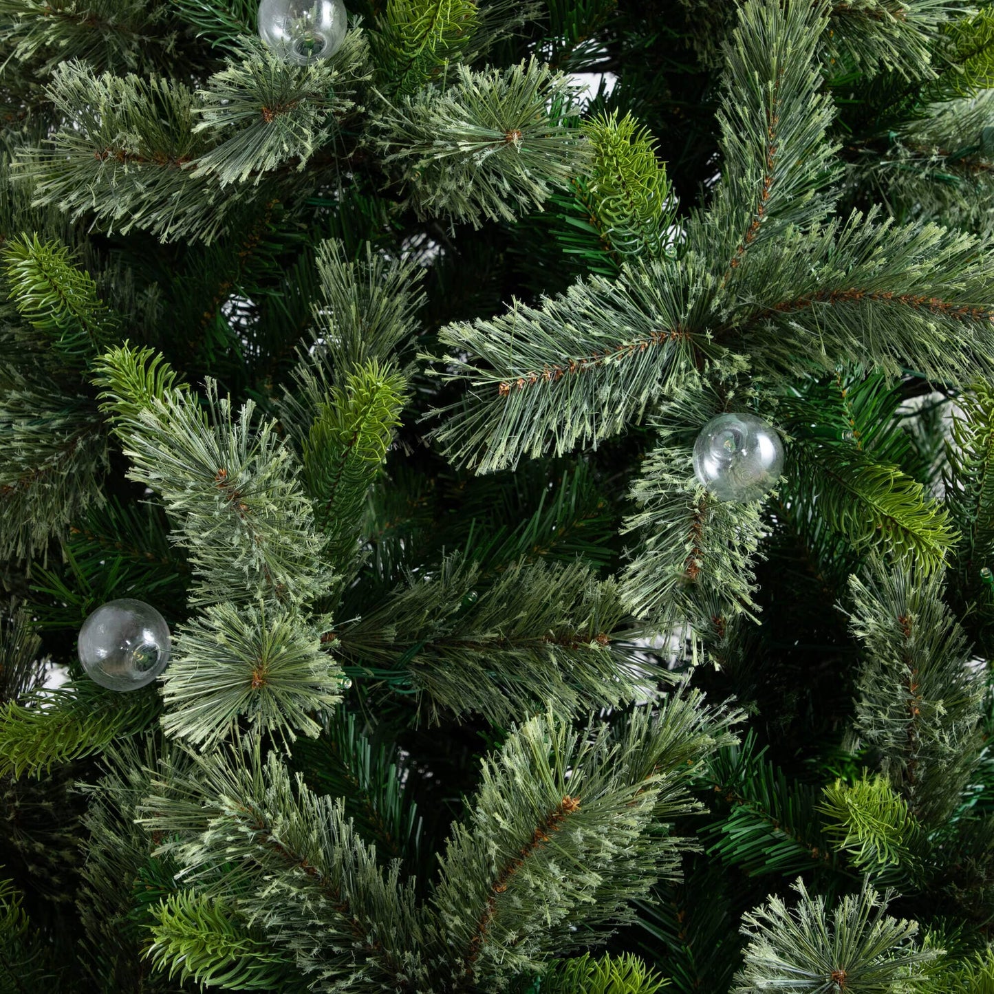 Nearly Natural 7.5' artificial Christmas tree close-up of frosted needles with clear bulbs on Tampa Home & Garden Store