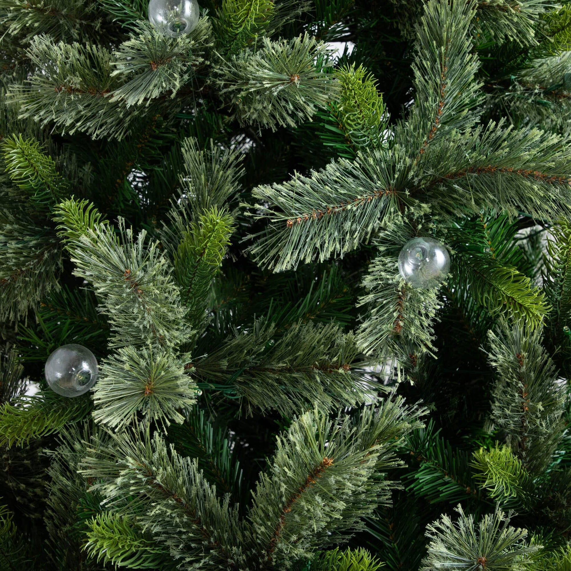 Nearly Natural 7.5' artificial Christmas tree close-up of frosted needles with clear bulbs on Tampa Home & Garden Store