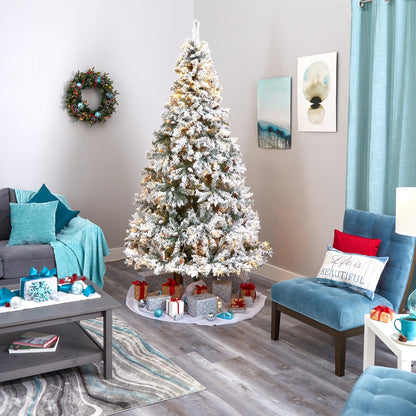 8' flocked white pine Christmas tree by Nearly Natural with pinecones and 500 LED lights in room on Tampa Home & Garden Store