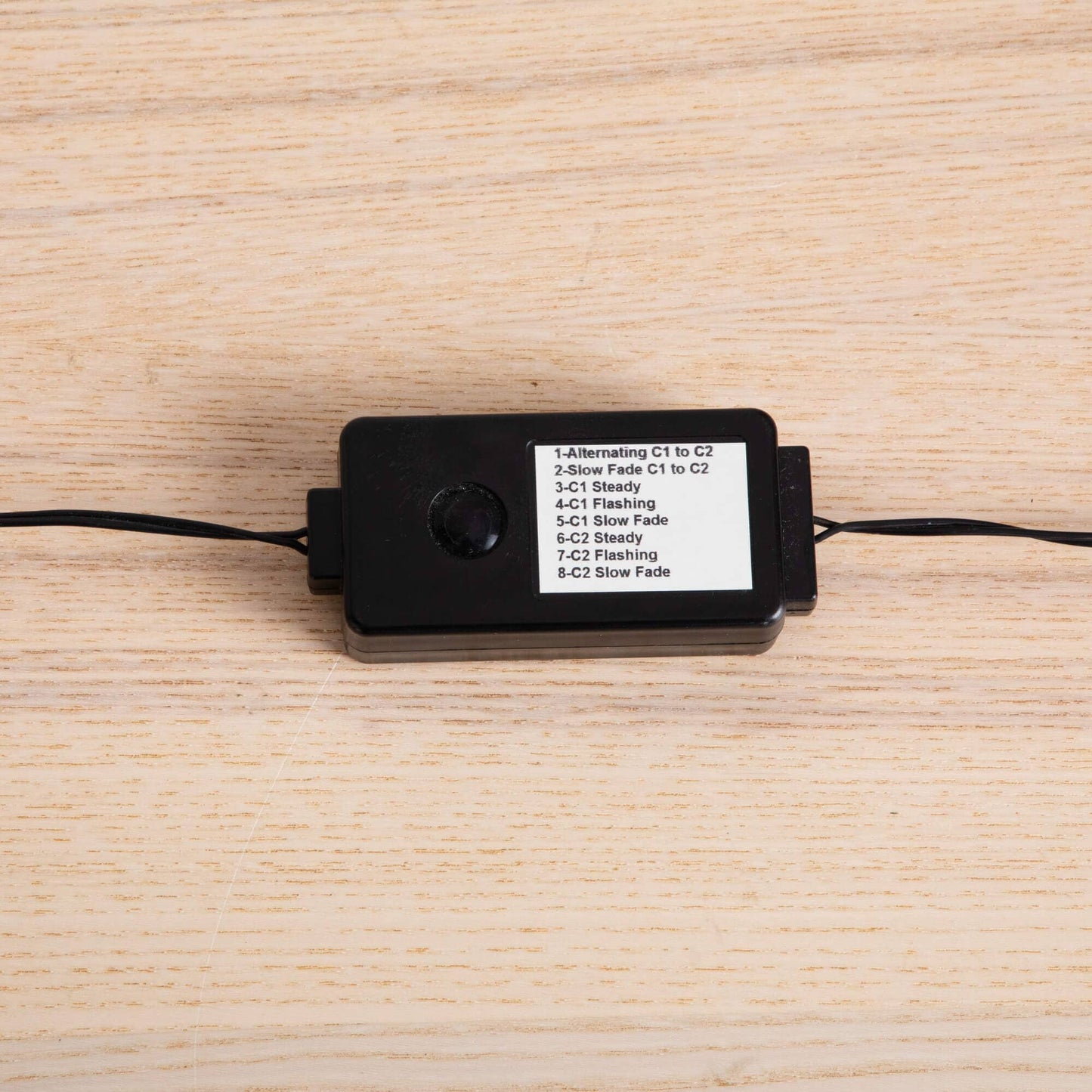 Black LED light controller box with a white label listing mode options on a wooden surface on Tampa Home & Garden Store