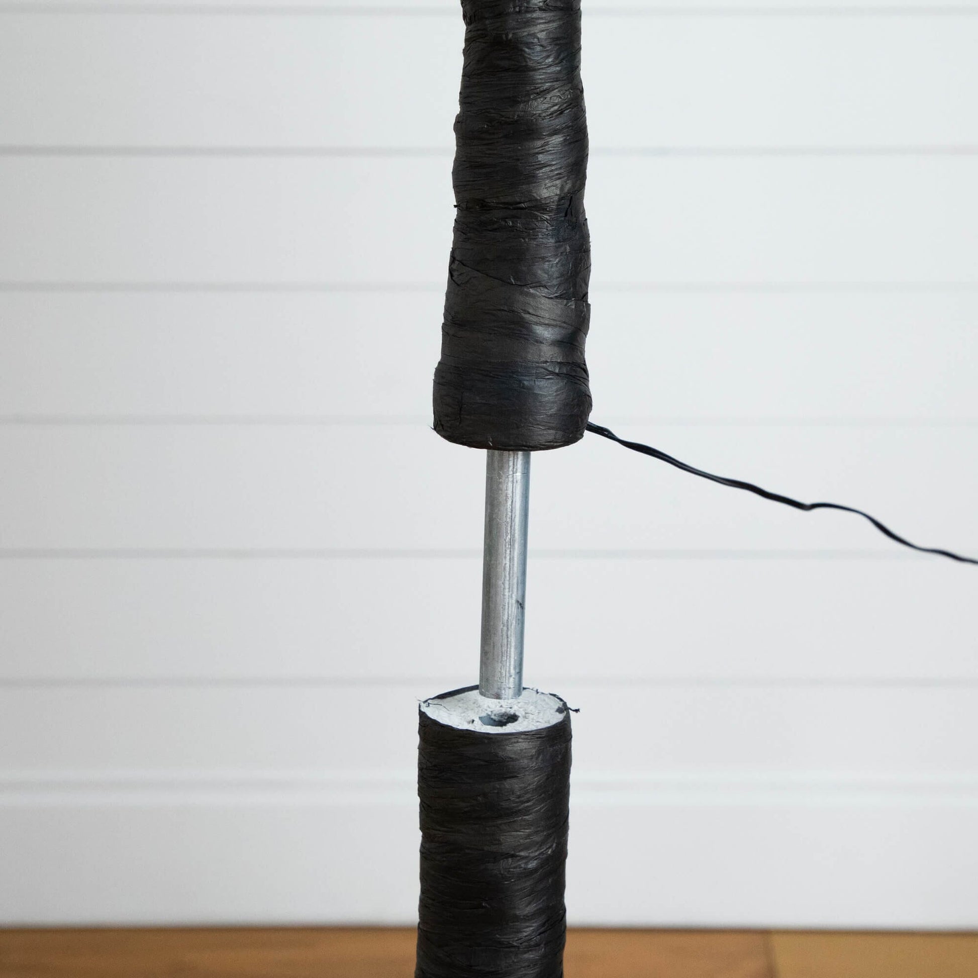 8' Nearly Natural black twig artificial tree trunk wrapped in tape with power cord visible on Tampa Home & Garden Store