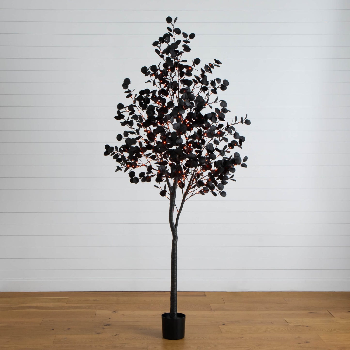 8 ft pre-lit Halloween black eucalyptus tree with 540 orange and purple LEDs in a black planter on Tampa Home & Garden Store