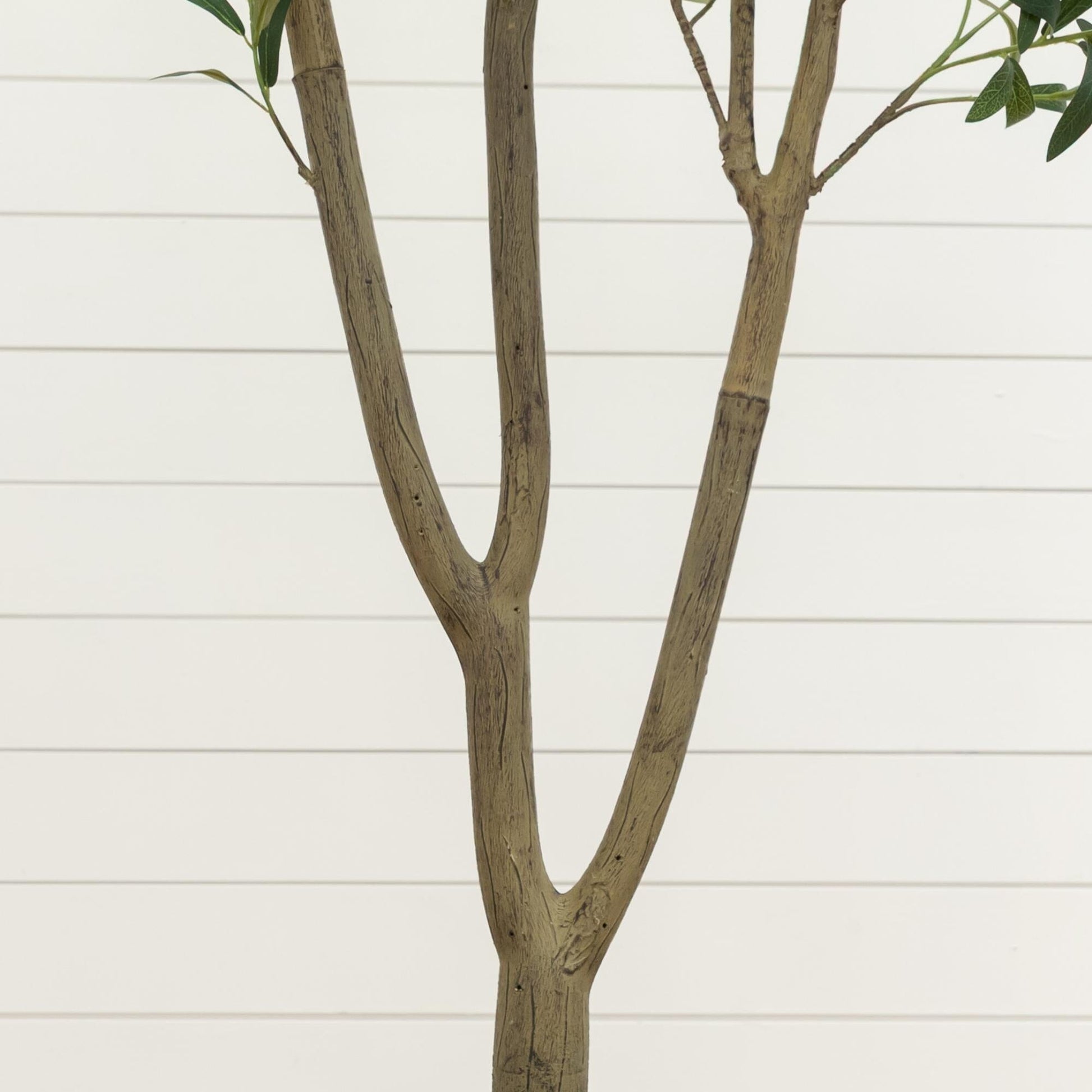 Artificial olive tree with three brown trunks and green leaves against a light background on Tampa Home & Garden Store