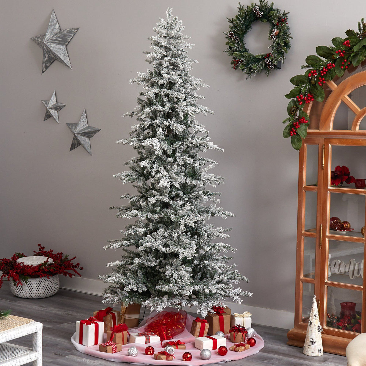 8.5 ft Slim Flocked Nova Scotia Spruce Artificial Christmas Tree by Nearly Natural, snow-dusted evergreen with gifts beneath on Tampa Home & Garden Store
