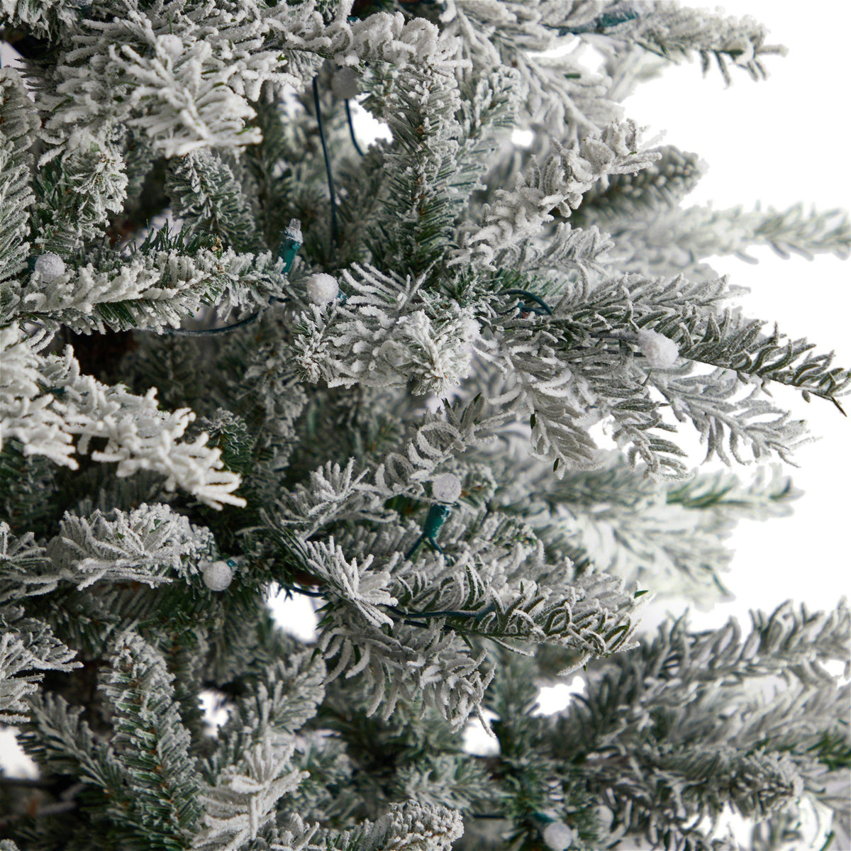 8.5’ Slim Flocked Nova Scotia Spruce artificial Christmas tree with snow-coated branches on Tampa Home & Garden Store