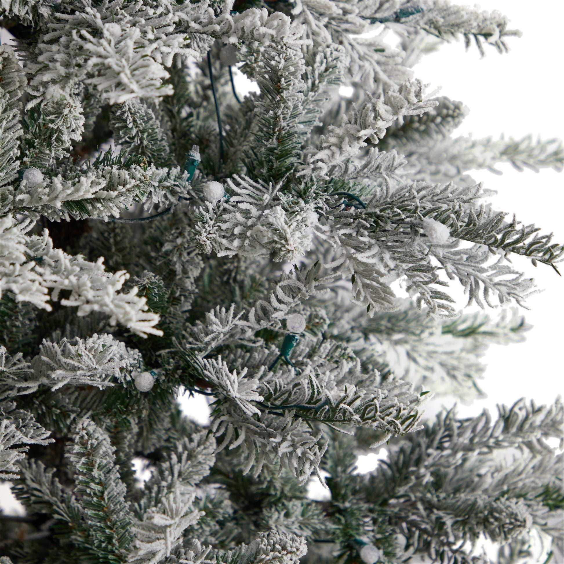8.5’ Slim Flocked Nova Scotia Spruce artificial Christmas tree with snow-coated branches on Tampa Home & Garden Store