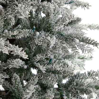 8.5’ Slim Flocked Nova Scotia Spruce artificial Christmas tree with snow-coated branches on Tampa Home & Garden Store
