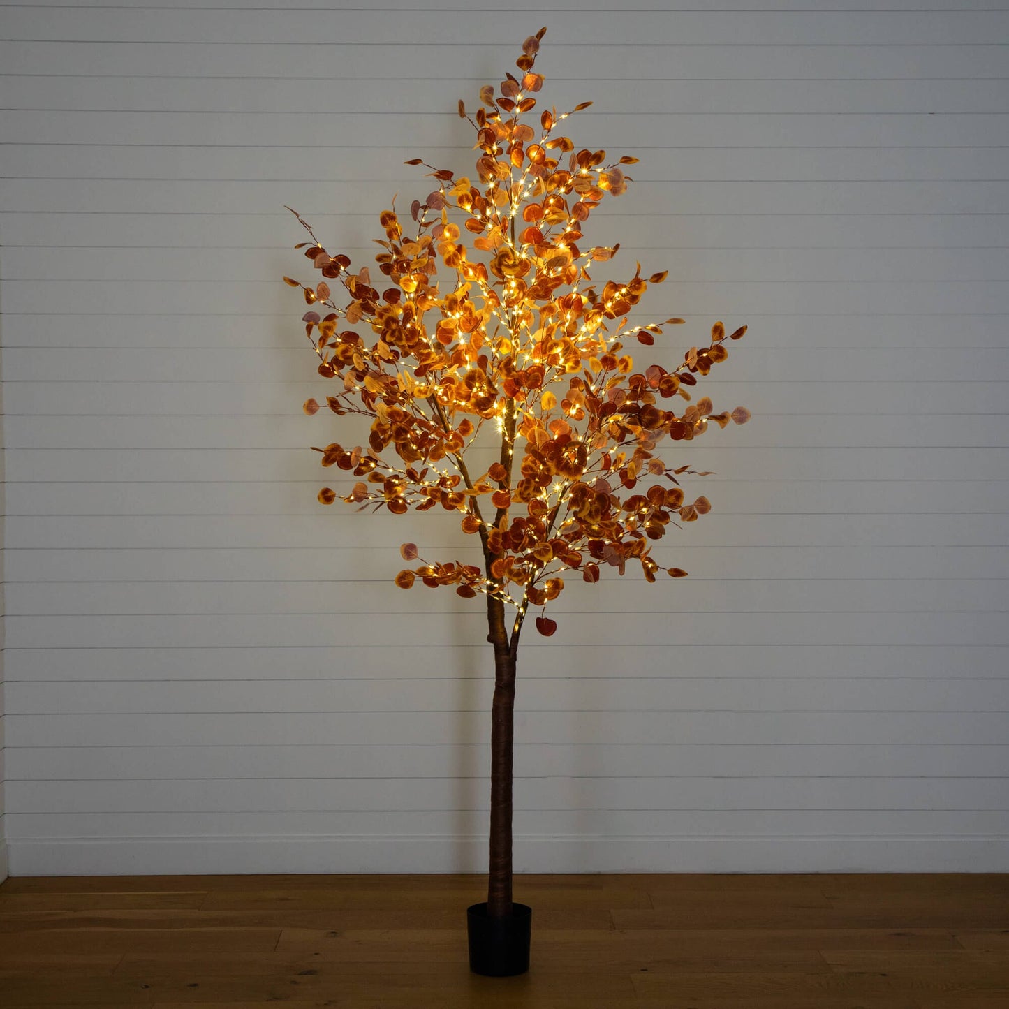 9' pre-lit autumn eucalyptus artificial tree with 700 warm white LEDs, orange leaves in black pot on Tampa Home & Garden Store