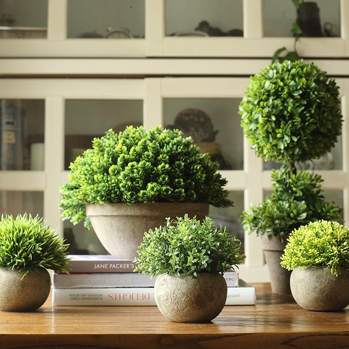 RusticReach artificial boxwood topiaries in designs; group of lush green spheres in stone pots on Tampa Home & Garden Store