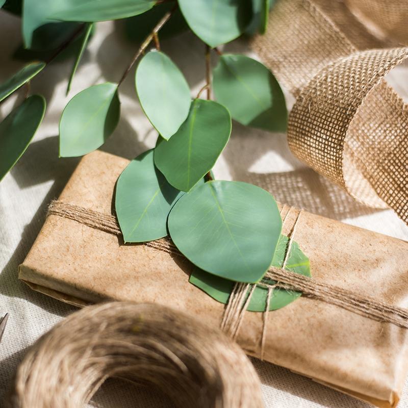 Artificial Eucalyptus Leaves by RusticReach, faux greenery on a wrapped gift with burlap ribbon on Tampa Home & Garden Store