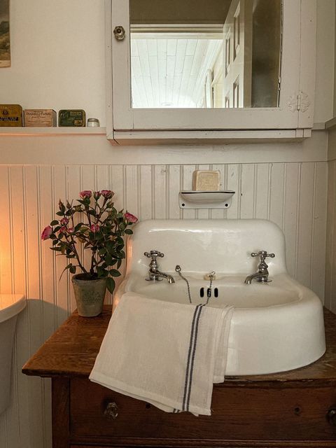 French Rose Garden artificial pink roses in a pot on a vanity with a white sink Nearly Natural on Tampa Home & Garden Store