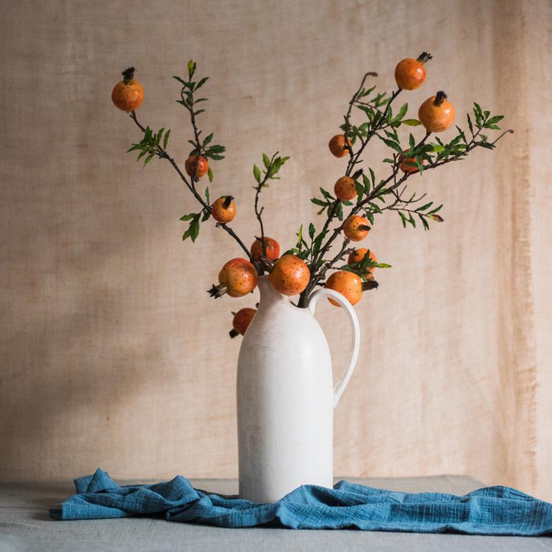 Artificial fruit stem with yellow orange pomegranates RusticReach, 36 inches tall in a white pitcher on Tampa Home & Garden Store