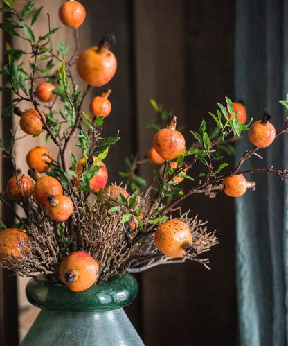 Artificial fruit stem with yellow-orange pomegranate berries on woody branches in a green ceramic vase, 36in tall on Tampa Home & Garden Store