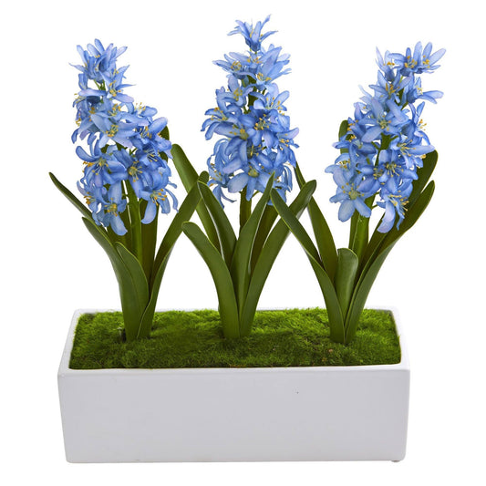 Blue hyacinth artificial arrangement in white vase with green leaves and moss on Tampa Home & Garden Store