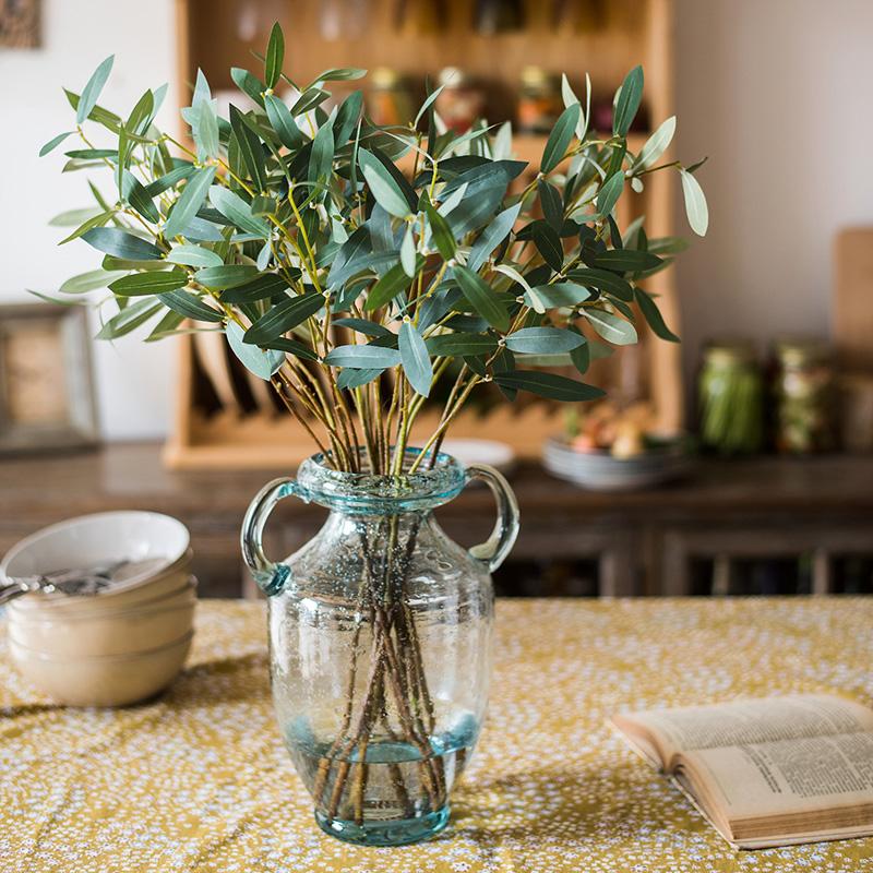 Artificial Faux Olive Leaf Stem RusticReach in a clear glass vase with green olive leaves on Tampa Home & Garden Store