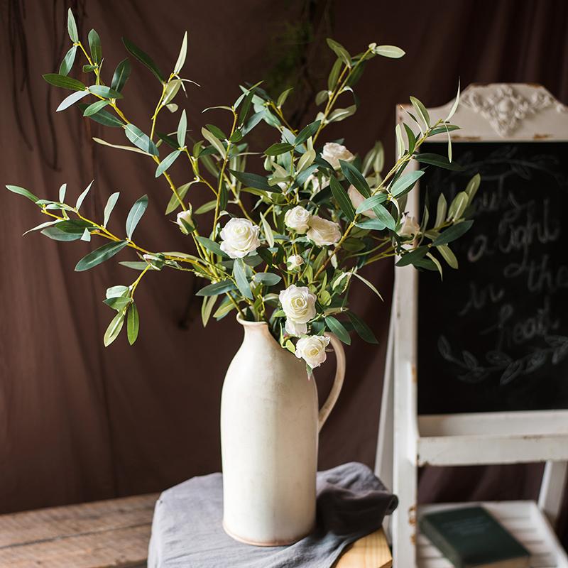 Artificial Faux Olive Leaf Stem by RusticReach in a ceramic pitcher with white faux roses on Tampa Home & Garden Store