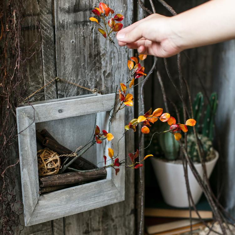 Artificial Red Vine Leaf Stem Faux plant RusticReach orange leaves beside gray frame planter on Tampa Home & Garden Store
