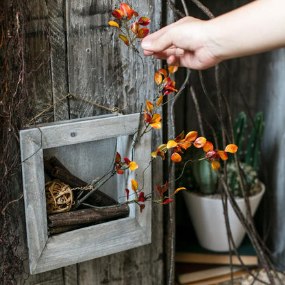 Artificial Red Vine Leaf Stem Faux plant RusticReach orange leaves beside gray frame planter on Tampa Home & Garden Store