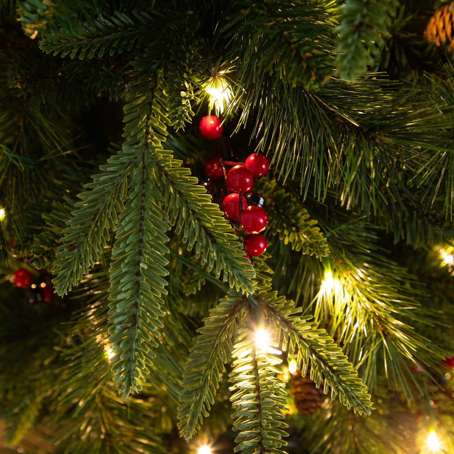 Nearly Natural pre-lit Christmas greenery close-up: pine needles, warm white lights, red berries on Tampa Home & Garden Store