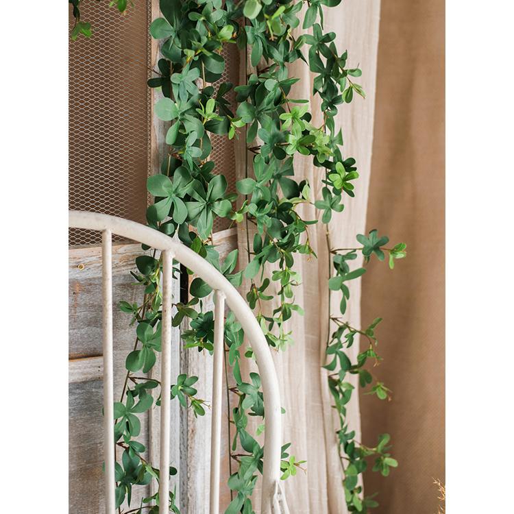 Artificial Vine Schefflera Leaf by RusticReach, green trailing vine draped over rustic chair on Tampa Home & Garden Store