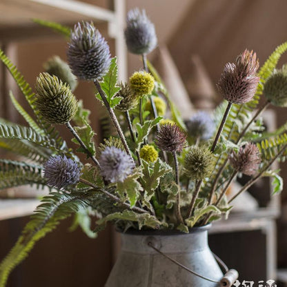 Faux silk thistle flower stem bouquet in mixed purple and olive-green hues in a metal vase on Tampa Home & Garden Store