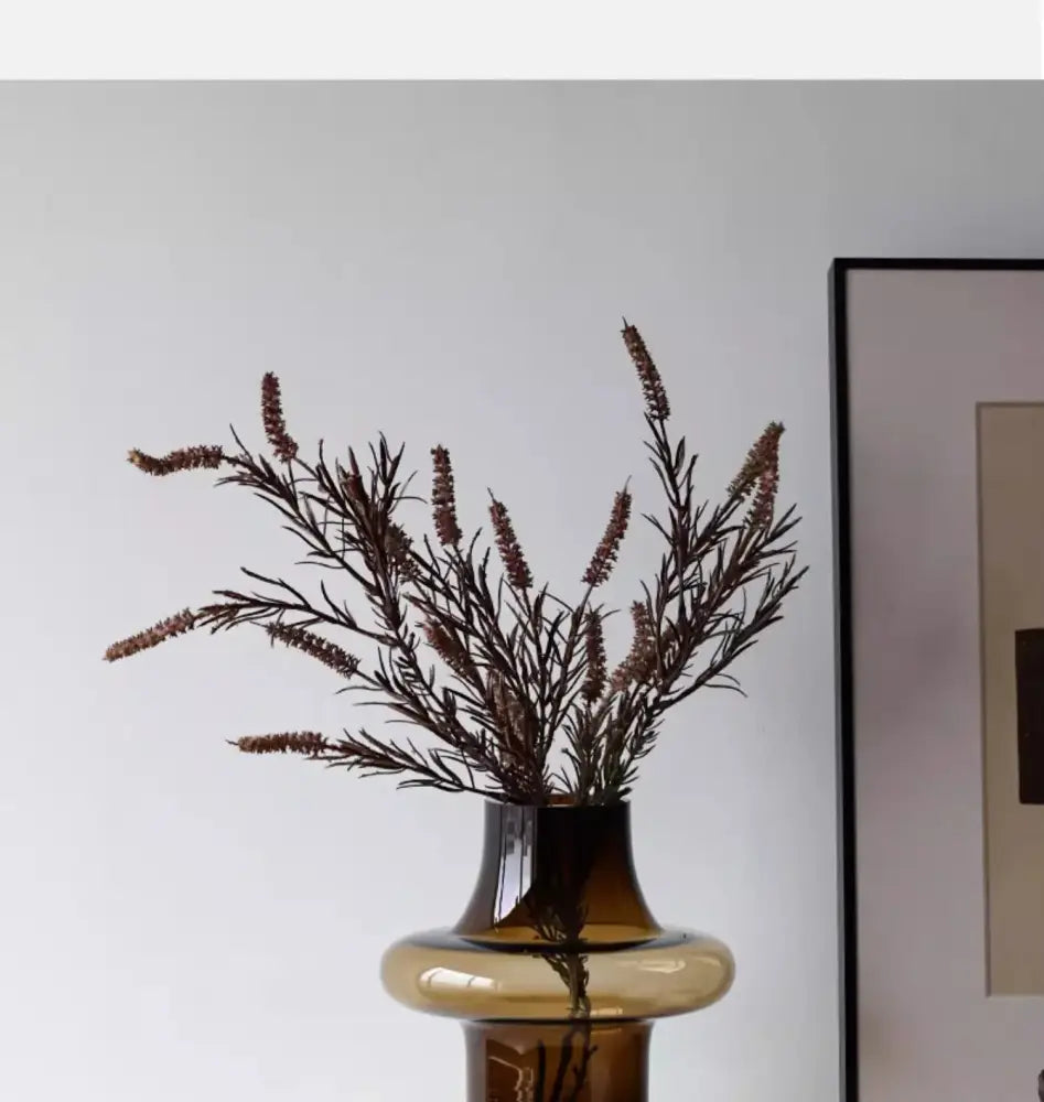 Amber glass bulbous vase with a wide rounded bottom and narrow neck on Tampa Home & Garden Store