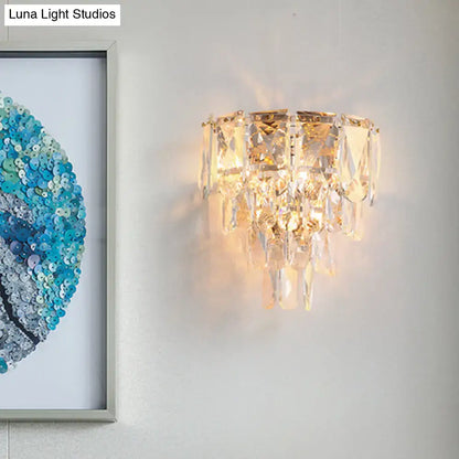 Gold Crystal Tiered Lamp wall sconce with hanging crystal prisms by Decorbites, warm glow on Tampa Home & Garden Store