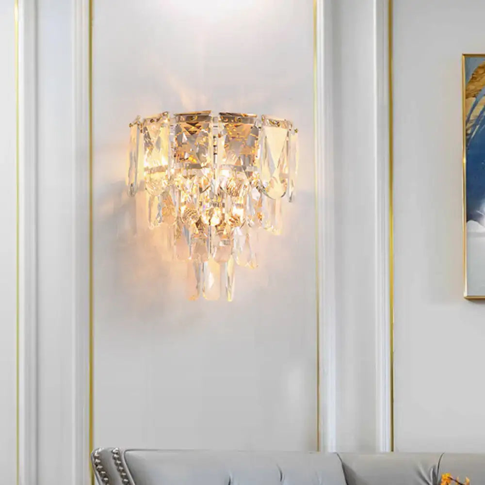 Gold crystal tiered wall lamp with hanging prisms and warm glow on Tampa Home & Garden Store