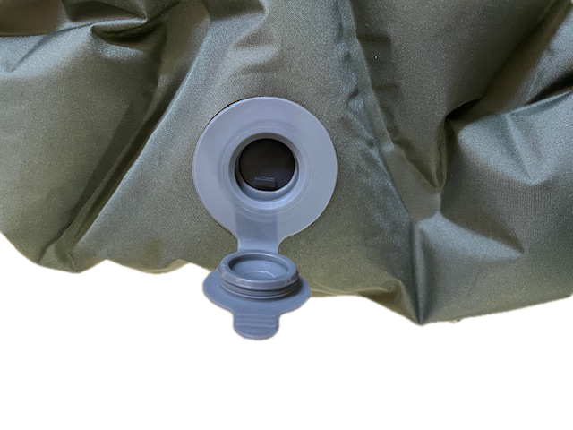 Olive green sleeping pad with open inflation valve and cap on Tampa Home & Garden Store