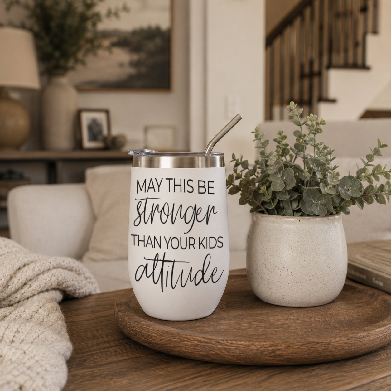 Gia Roma Kids Attitude 17oz tumbler with straw, white with black script, on a tray beside a planter on Tampa Home & Garden Store