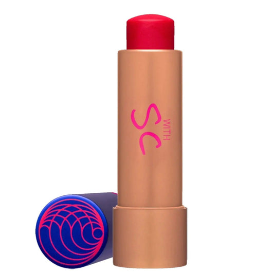 Tinted Lip Balm by Augustinus Bader in peachtan tube with blue cap and pink swirl logo on Tampa Home & Garden Store