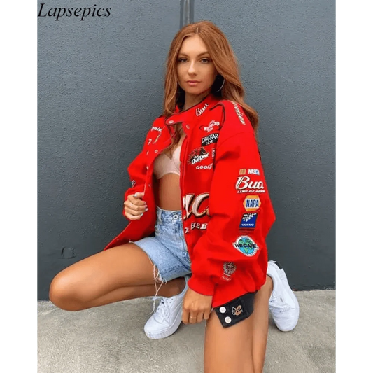 Stevvex red printed oversized jacket with patch logos worn over a beige top and denim shorts on Tampa Home & Garden Store