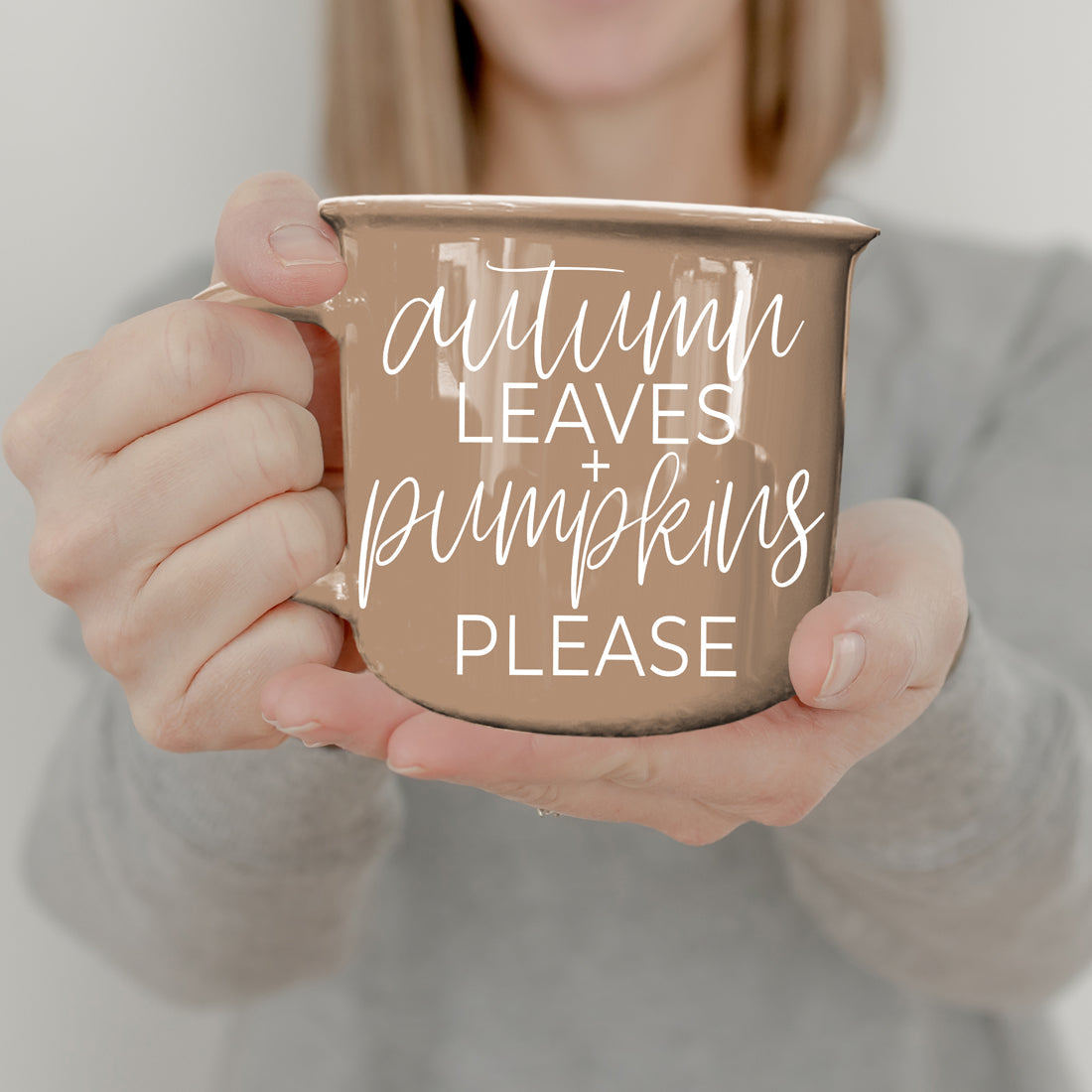 Autumn Leaves coffee mug by Gia Roma, warm tan ceramic held by hands on Tampa Home & Garden Store
