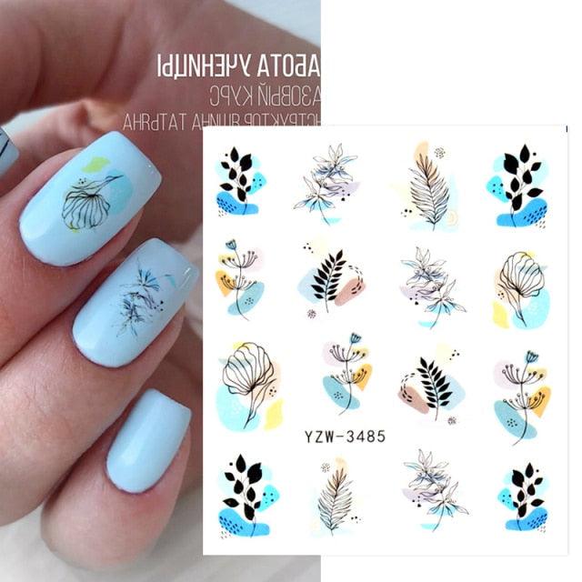 Stevvex Avocado fruit transfer nail stickers on light blue nails with botanical leaves on Tampa Home & Garden Store