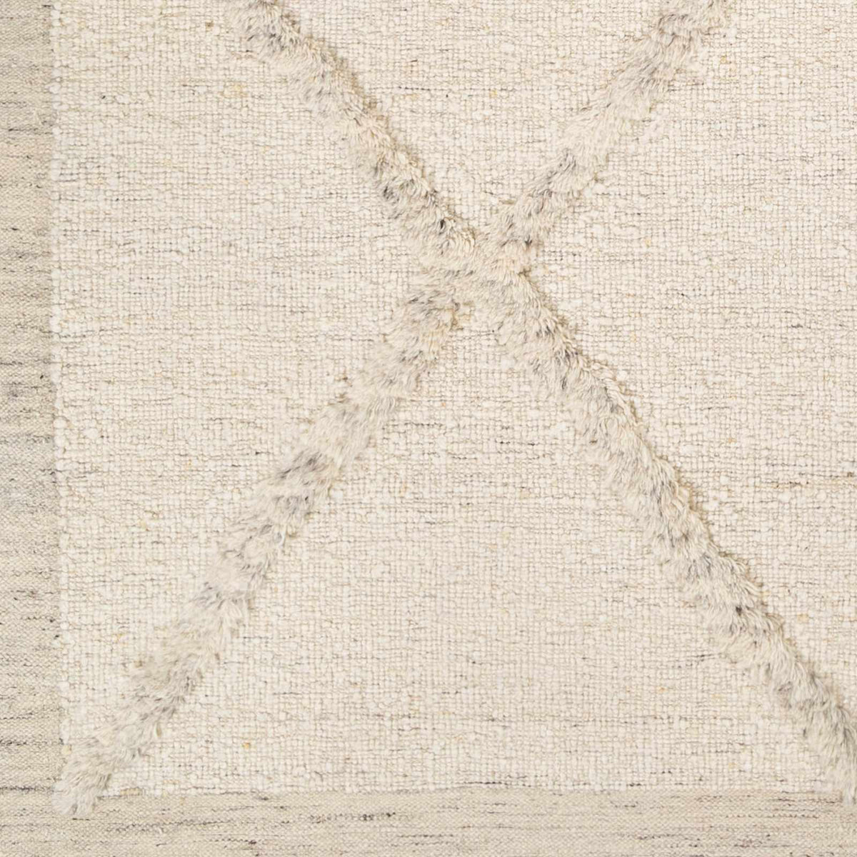 Awen hand-knotted wool area rug in creamy beige with subtle texture and fringe on Tampa Home & Garden Store