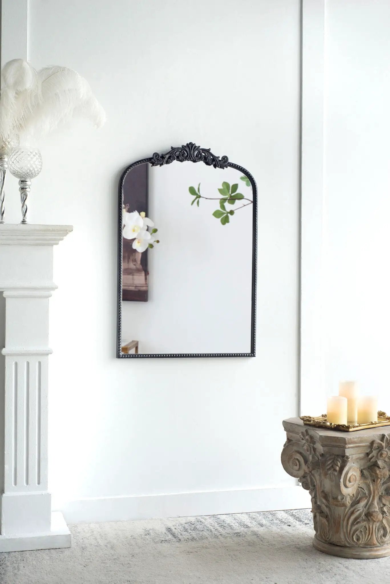 Arch mirror with black baroque ornate frame wall decor reflecting orchid leaves on Tampa Home & Garden Store