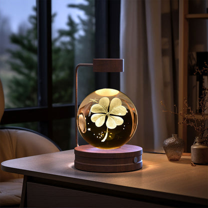 Crystal ball night light on wooden base with arc metal stand, warm amber glow and floral etching on Tampa Home & Garden Store