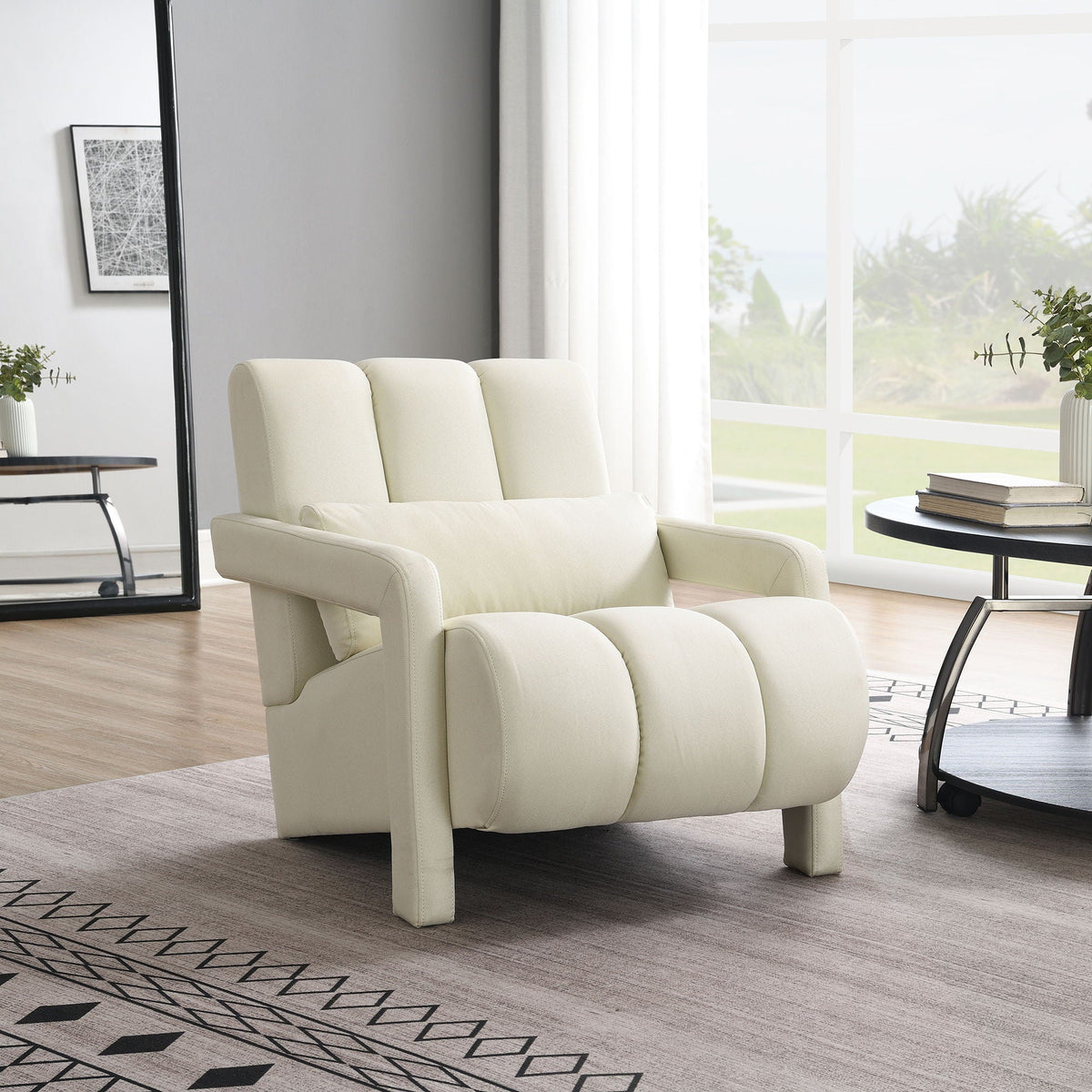 Modern upholstered accent arm chair with pillow in cream fabric, living room by large window on Tampa Home & Garden Store